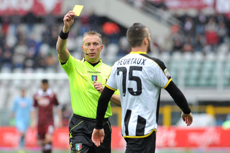 a referee showing a yellow card